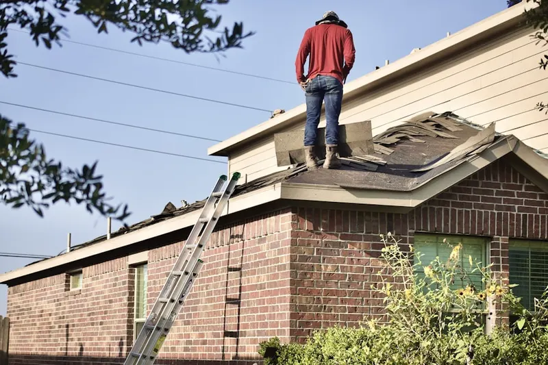 Professional roofer working on a residential roof in Salem Corner